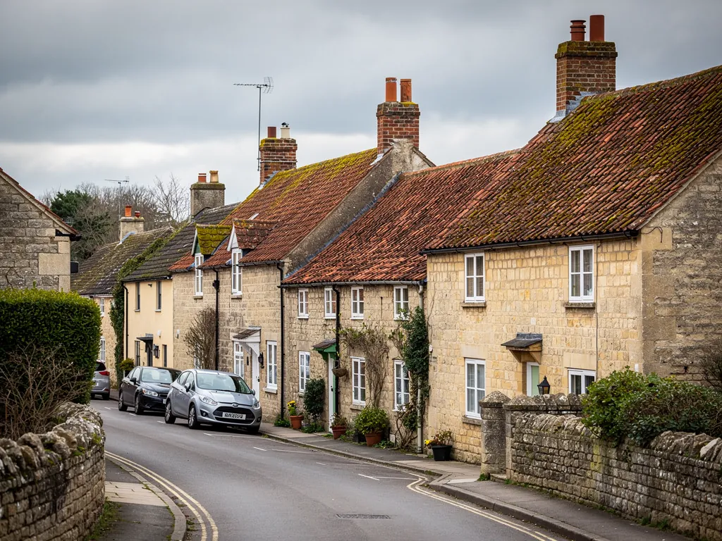 A Somerset village street of stone cottages with clay pantile roofs